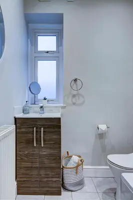 a bathroom with a sink and a window at The Fullarton - Coorie Doon Stays in Troon