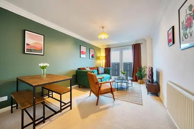 a living room with a couch and a table at 2BR Flat Central Location with Free Parking in Glasgow