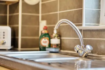 a kitchen sink with a faucet on a counter at 2BR Flat Central Location with Free Parking in Glasgow