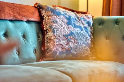 a blue couch with a pillow on top of it at 2BR Flat Central Location with Free Parking in Glasgow