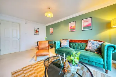 a living room with a blue couch and a table at 2BR Flat Central Location with Free Parking in Glasgow