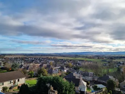 a town with houses and mountains in the distance at The Tower Gastro Pub & Apartments in Crieff