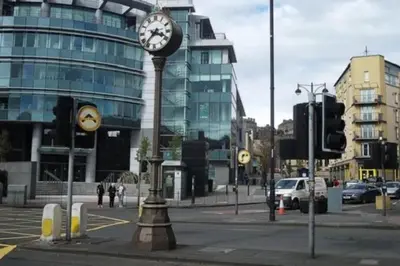 a clock on a pole in the middle of a street at Flat in Central Edinburgh New Town , Lothian Road Heart of Edinburgh Flat Sleeps 4 in Edinburgh