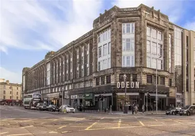 a large building on a street with cars parked in front at Flat in Central Edinburgh New Town , Lothian Road Heart of Edinburgh Flat Sleeps 4 in Edinburgh