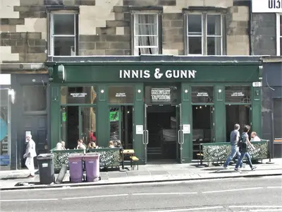 people walking on the sidewalk in front of a restaurant at Flat in Central Edinburgh New Town , Lothian Road Heart of Edinburgh Flat Sleeps 4 in Edinburgh