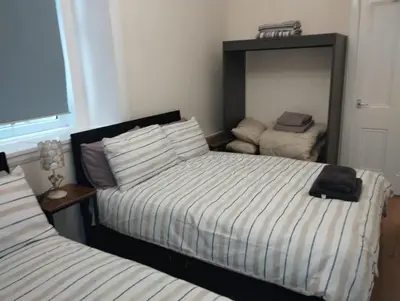 a bedroom with two beds and a mirror at Flat in Central Edinburgh New Town , Lothian Road Heart of Edinburgh Flat Sleeps 4 in Edinburgh