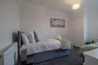 a bedroom with a bed with pillows on it at Westlea House in Airdrie