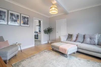 a living room with a couch and a table at Westlea House in Airdrie
