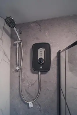 a shower in a bathroom next to a shower at Franklin Place in East Kilbride