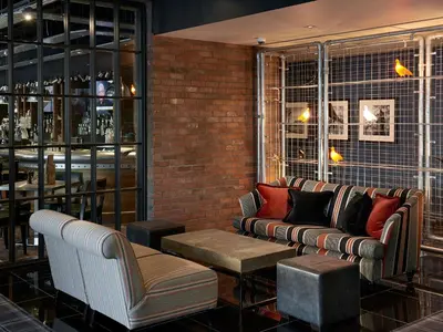 a living room with a couch and a table at Village Hotel Glasgow in Glasgow