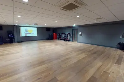 a large room with a wooden floor and a projection screen at Village Hotel Glasgow in Glasgow