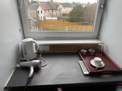 a room with a window and a desk with a keyboard at Gothenburg Hotel in Rosyth