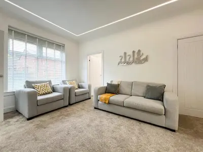 a living room with two couches and a window at Stylish Modern Glasgow Home with Excellent Value in Glasgow