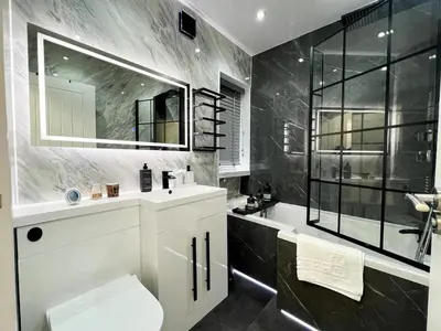 a bathroom with a toilet and a sink and a mirror at Stylish Modern Glasgow Home with Excellent Value in Glasgow