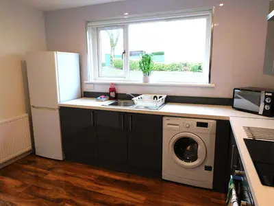 a kitchen with a sink and a washing machine at 4 Bedroom Newly Refurbished Home in East Kilbride in East Kilbride