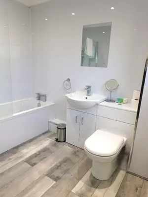 a white bathroom with a toilet and a sink at 4 Bedroom Newly Refurbished Home in East Kilbride in East Kilbride