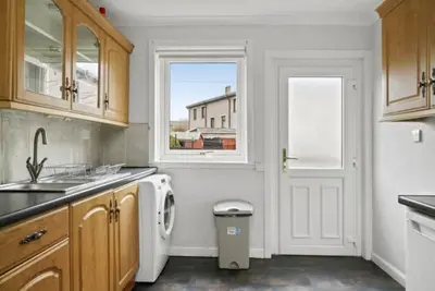 a kitchen with a sink and a white refrigerator at BridgeCity Hidden Gem in the heart of Falkirk Roughland house Stirlingshire in Carron