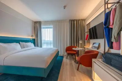 a hotel room with a large bed and a desk at The Social Hub Glasgow Extended Stay in Glasgow