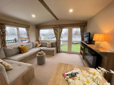 a living room with a couch and a tv at Cosy 3BR Getaway in Beautiful Country Park - Pass the Keys in Beattock