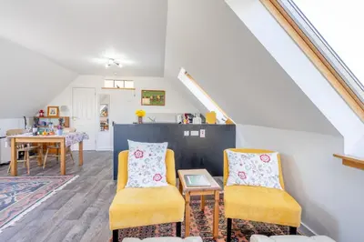 a living room with two chairs and a table at 1 Bed in Methven oc-v30533 in Methven