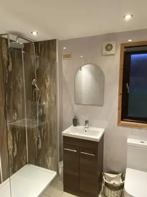 a bathroom with a shower and a sink at Lomond Lodge Rowardennnan in Rowardennan