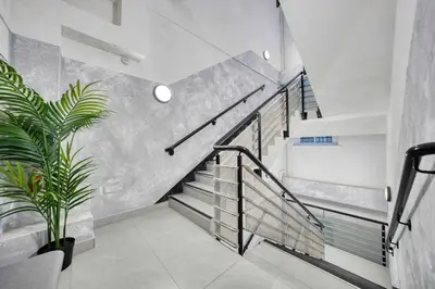 a staircase in a house with a potted plant at Large Central Station 2 Bed Apartment A2 in Glasgow