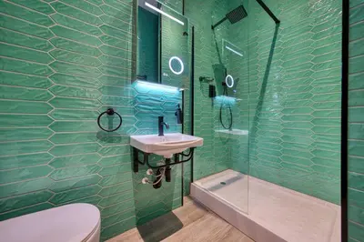 a green bathroom with a sink and a shower at Spacious Central Station 2 Bed Apartment B3 in Glasgow
