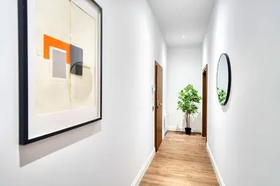 a hallway of a house with white walls and a mirror at Spacious Central Station 2 Bed Apartment B3 in Glasgow