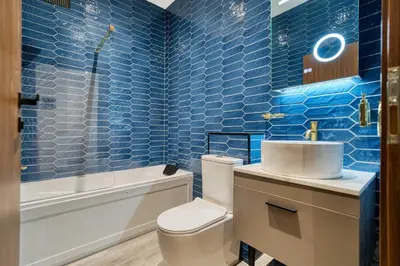 a blue bathroom with a toilet and a sink at Grand Central Station 1 Bed Apartment A5 in Glasgow