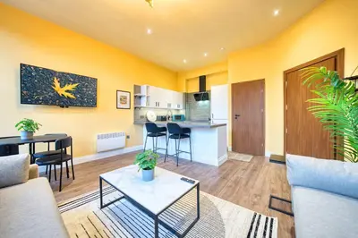 a living room with a couch and a table at Lovely Central Station 1 Bed Apartment A6 in Glasgow