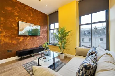 a living room with a couch and a table at Stunning Central Station 1 Bed Apartment A7 in Glasgow
