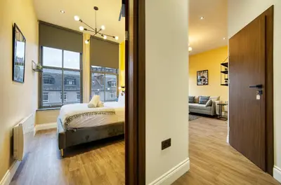 a bedroom with a bed and a living room at Stunning Central Station 1 Bed Apartment A7 in Glasgow