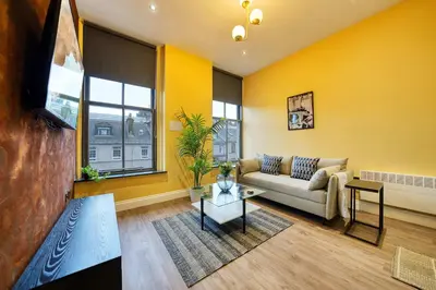 a living room with a couch and a table at Stunning Central Station 1 Bed Apartment A7 in Glasgow