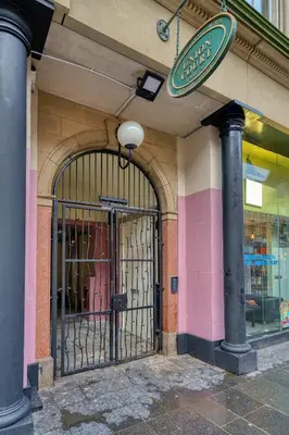 an entrance to a store with a gate on a building at Stunning Central Station 1 Bed Apartment A7 in Glasgow