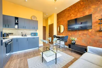 a kitchen and living room with a couch and a table at Cozy Central Station 1 Bed Apartment B8 in Glasgow
