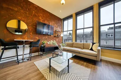 a living room with a couch and a table at Cozy Central Station 1 Bed Apartment B8 in Glasgow