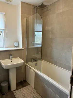 a bathroom with a sink and a tub and a shower at Modern Staycation Apartment in Caldercruix