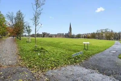 a park with a sign in the middle of a field at Spacious 3 bed home in Marchmont in Edinburgh