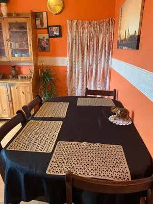 a dining room table with two chairs and a window at Little Universe in Edinburgh