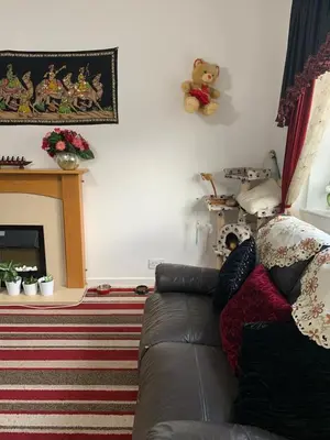 a living room with a couch and a fireplace at Little Universe in Edinburgh