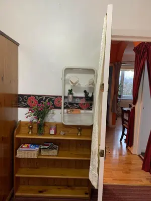 an open door to a room with a stair case at Little Universe in Edinburgh