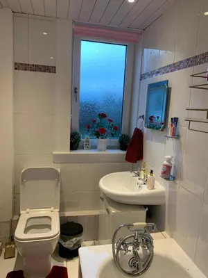 a bathroom with a toilet and a sink and a window at Little Universe in Edinburgh