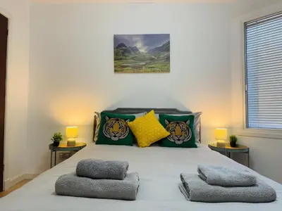 a bedroom with a bed with tiger pillows at Cozy Central Flat near Edinburgh Castle and with Free Private Parking in Edinburgh