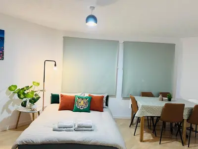 a bedroom with a bed and a table with chairs at Cozy Central Flat near Edinburgh Castle and with Free Private Parking in Edinburgh