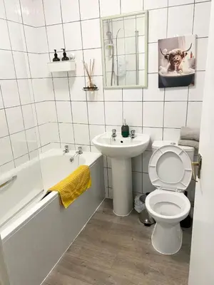 a bathroom with a toilet and a sink and a tub at Cozy Central Flat near Edinburgh Castle and with Free Private Parking in Edinburgh