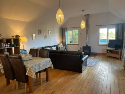 a living room with a couch and a table at Callanish Bothy in Benderloch