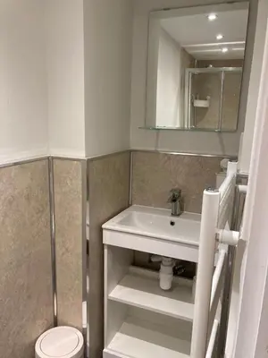 a bathroom with a sink and a toilet and a mirror at Gilmore Flat in Edinburgh