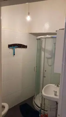 a bathroom with a shower and a toilet and a sink at Gilmore Flat in Edinburgh