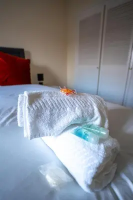 a towel sitting on top of a bed at 1 BDR Apartment At Caledonia Luxe Stays Short Lets & Serviced Accommodation Airdrie in Airdrie