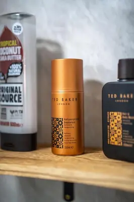 a shelf with two bottles of hair products on it at 1 BDR Apartment At Caledonia Luxe Stays Short Lets & Serviced Accommodation Airdrie in Airdrie